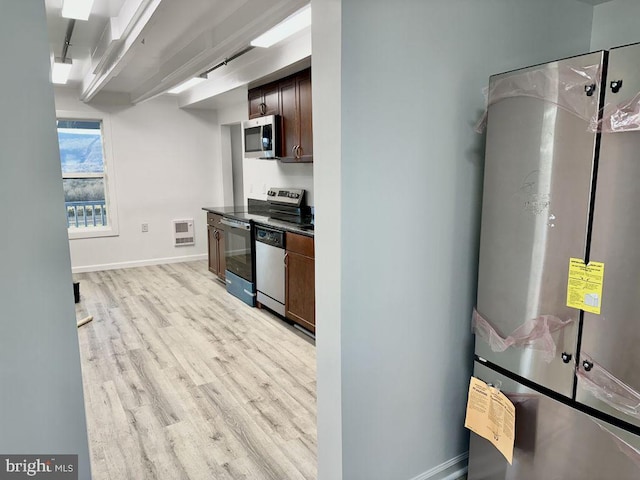 kitchen featuring dark brown cabinets, light hardwood / wood-style floors, appliances with stainless steel finishes, and heating unit