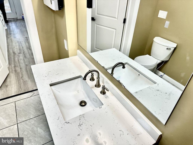 bathroom featuring tile patterned floors, vanity, and toilet