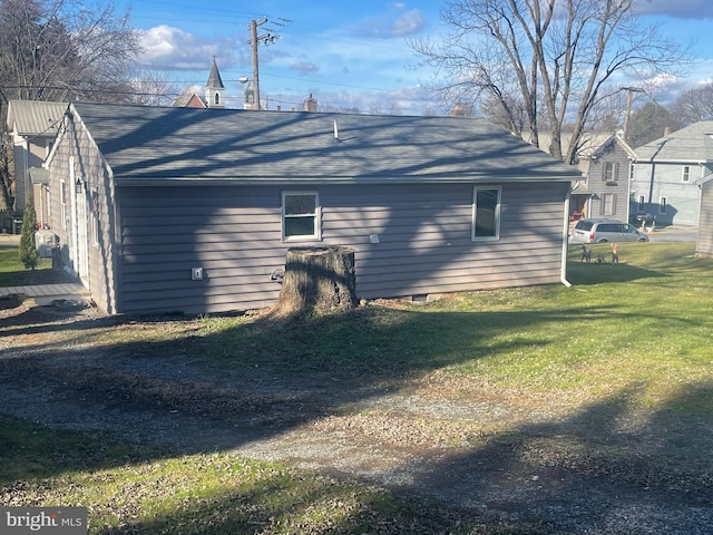 view of side of home featuring a lawn