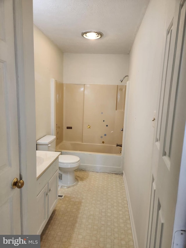 full bathroom with a textured ceiling, vanity, toilet, and  shower combination