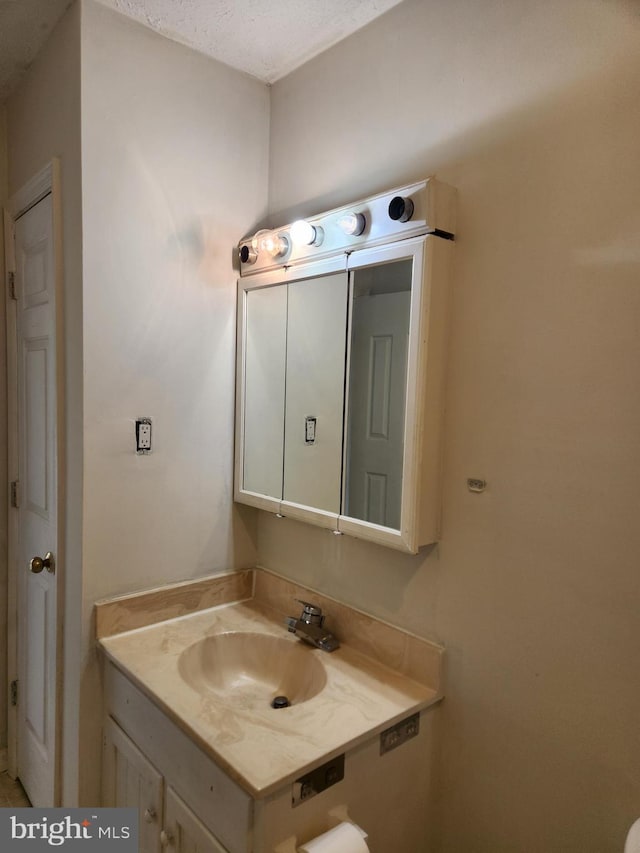 bathroom featuring vanity and a textured ceiling