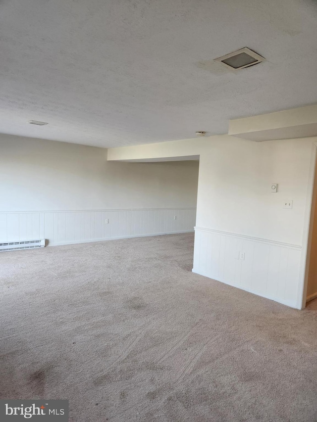 carpeted spare room featuring a textured ceiling