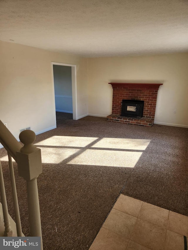 unfurnished living room featuring carpet floors and a brick fireplace