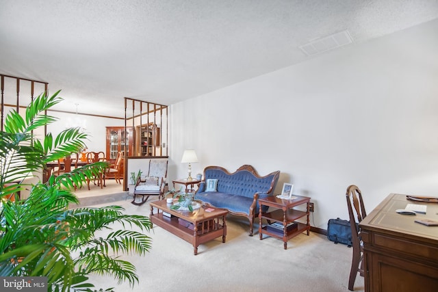 carpeted living room featuring a textured ceiling