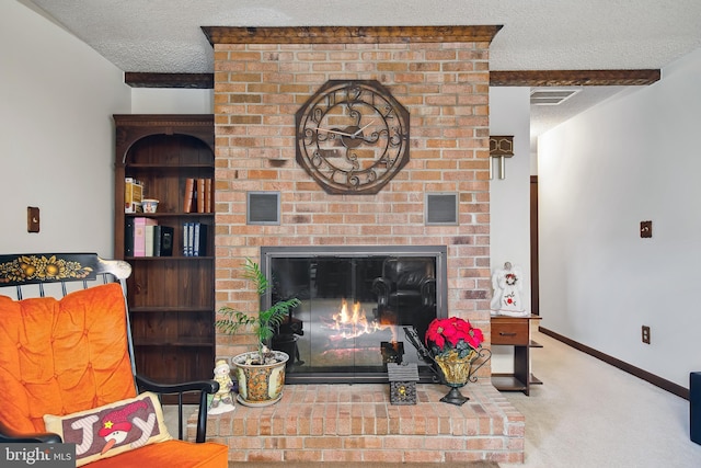 carpeted living room with beamed ceiling, a textured ceiling, and a brick fireplace