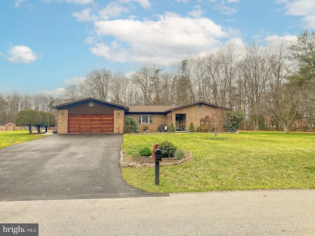 view of front of house featuring a front yard and a garage