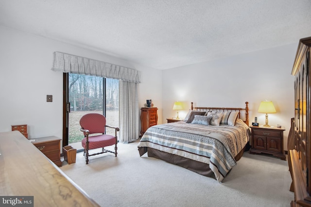 bedroom featuring a textured ceiling and light colored carpet