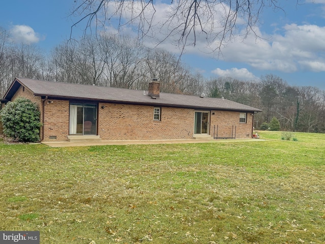 rear view of property featuring a lawn and a patio