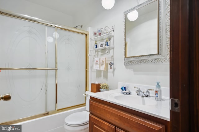 full bathroom with vanity, enclosed tub / shower combo, and toilet