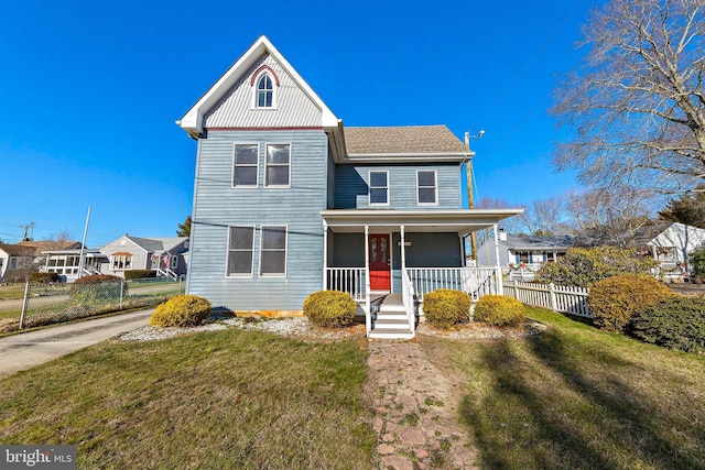 view of front facade with covered porch and a front yard