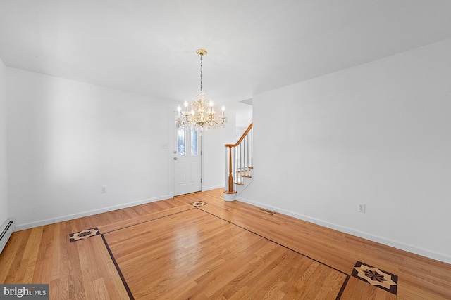 interior space with wood-type flooring and a notable chandelier