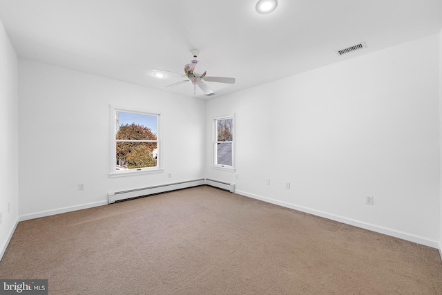 carpeted spare room featuring a baseboard radiator and ceiling fan