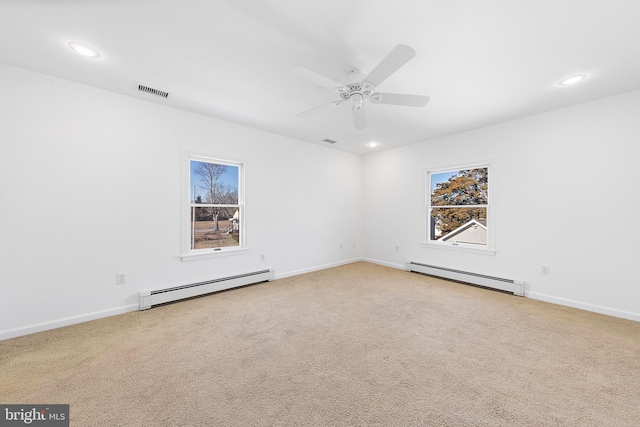 unfurnished room with carpet flooring, baseboard heating, and ceiling fan