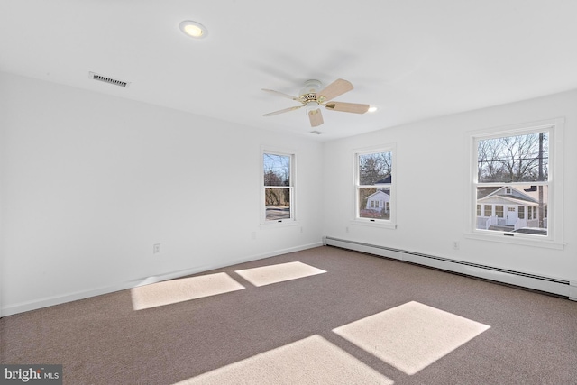 carpeted empty room with ceiling fan and a baseboard heating unit