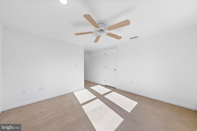 spare room featuring carpet and ceiling fan