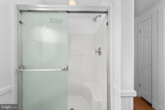 bathroom with hardwood / wood-style floors and walk in shower