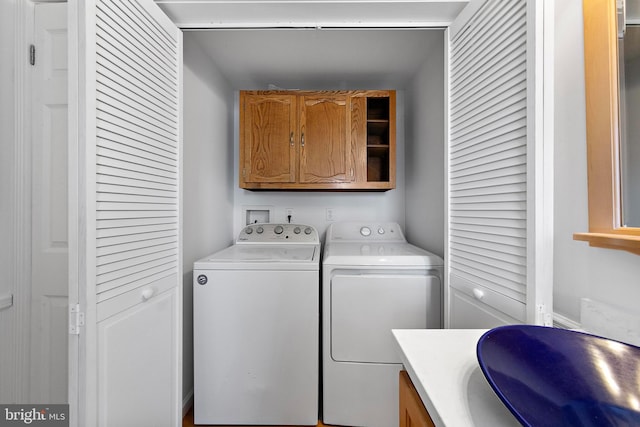 laundry area featuring cabinets and independent washer and dryer