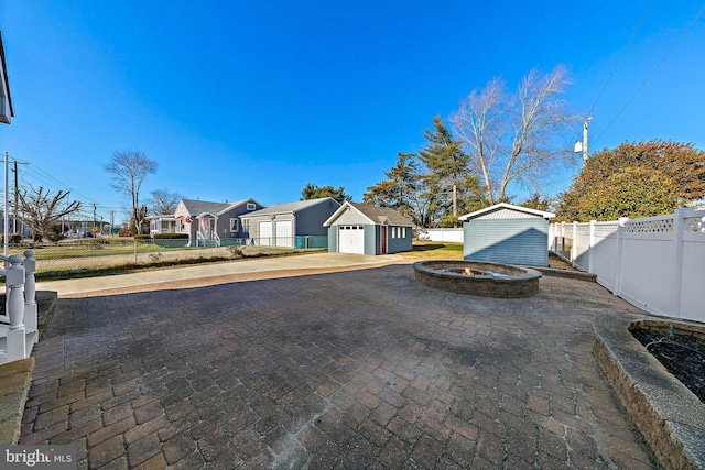 exterior space with an outbuilding and a fire pit