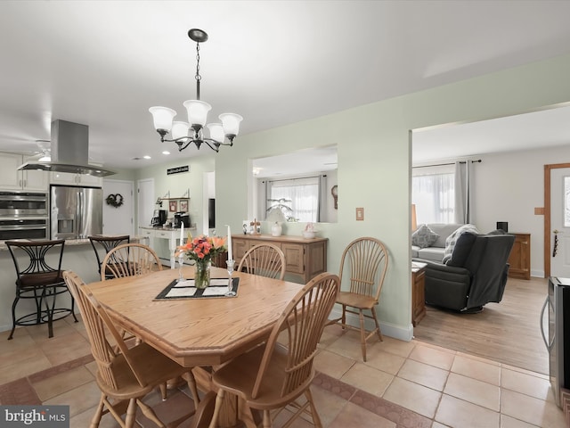 tiled dining area with a notable chandelier and a wealth of natural light