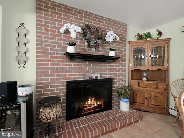 living room featuring light tile patterned flooring, baseboard heating, wine cooler, and a fireplace