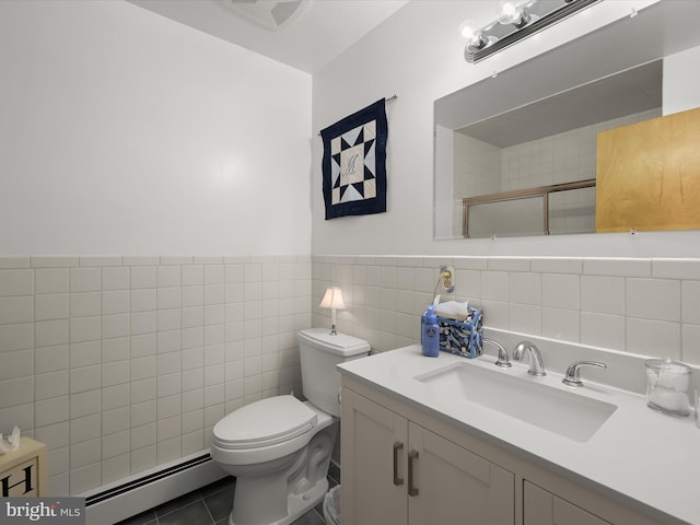 bathroom with baseboard heating, an enclosed shower, tile patterned floors, toilet, and vanity