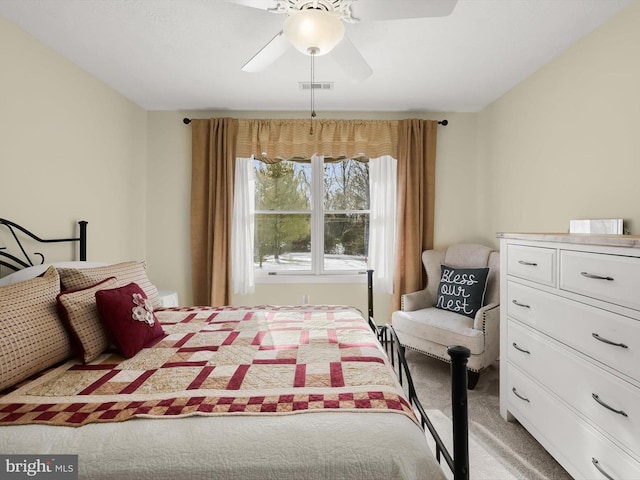 bedroom with ceiling fan and light carpet