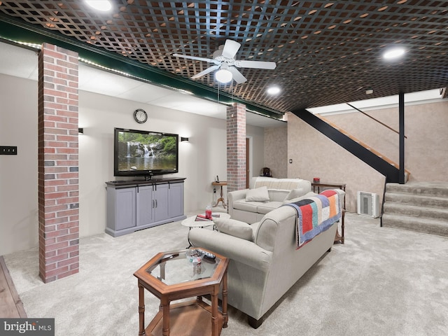 carpeted living room with ceiling fan and ornate columns