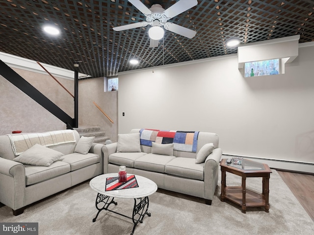 living room with hardwood / wood-style flooring, ceiling fan, and baseboard heating