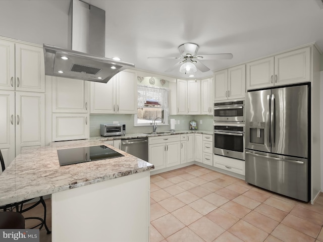 kitchen with appliances with stainless steel finishes, backsplash, extractor fan, white cabinetry, and light tile patterned floors