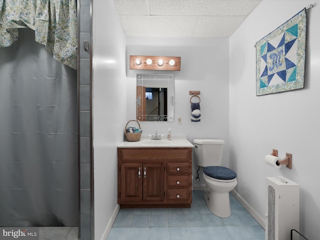 bathroom featuring tile patterned floors, toilet, vanity, and walk in shower