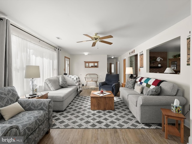 living room featuring hardwood / wood-style flooring and ceiling fan