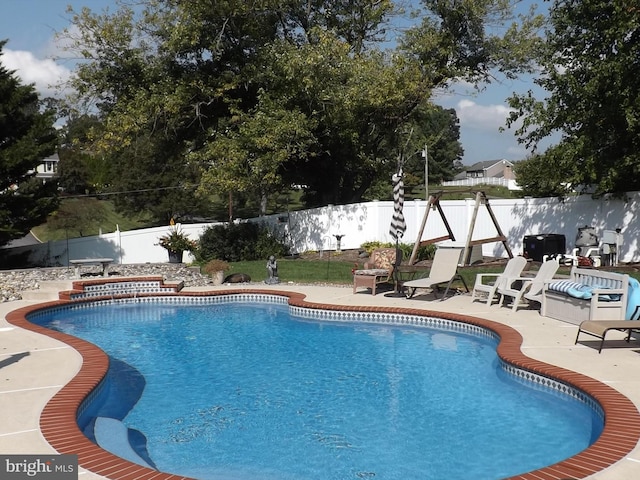 view of swimming pool with a patio