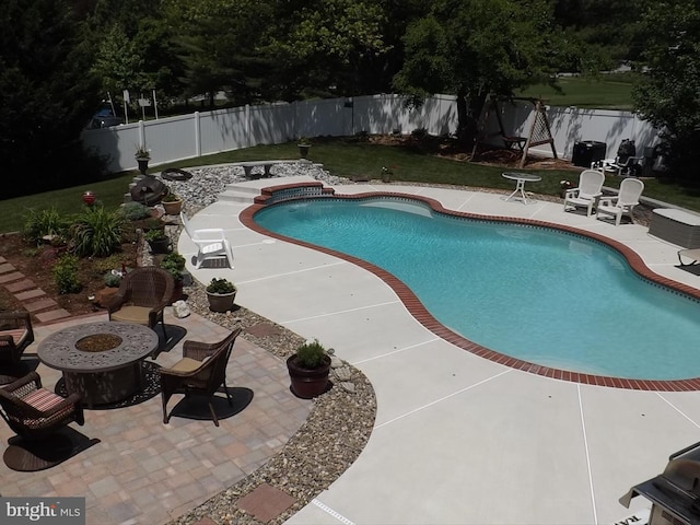 view of pool featuring a patio area and an outdoor fire pit