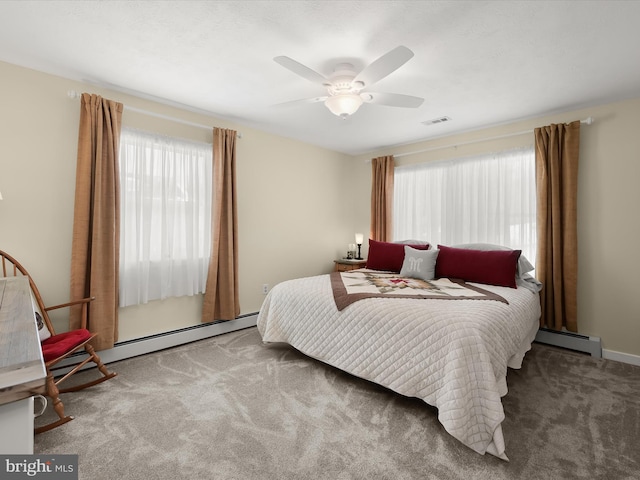 carpeted bedroom featuring ceiling fan and a baseboard heating unit