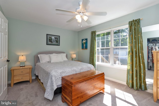 bedroom featuring light carpet and ceiling fan