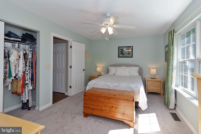 bedroom with carpet, multiple windows, a closet, and ceiling fan