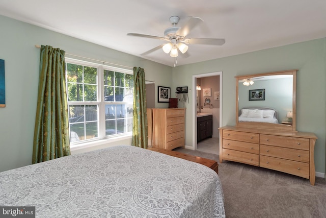 carpeted bedroom featuring ceiling fan and connected bathroom