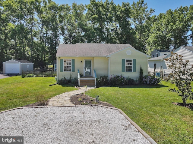 view of front of home featuring an outbuilding, a front lawn, and a garage