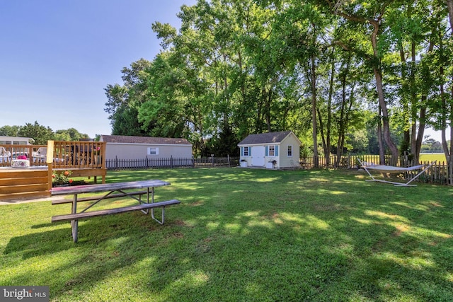 view of yard featuring a wooden deck and an outbuilding