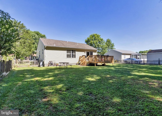 back of house featuring a yard and a deck