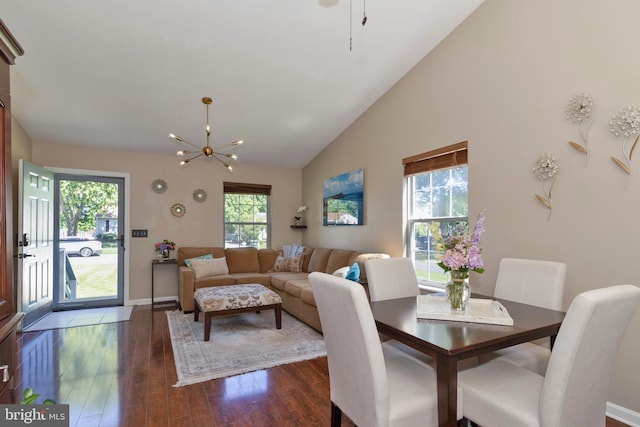 dining space featuring lofted ceiling, dark hardwood / wood-style floors, and an inviting chandelier