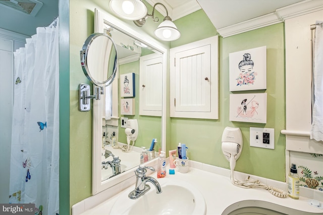 bathroom featuring a shower with curtain, sink, and crown molding