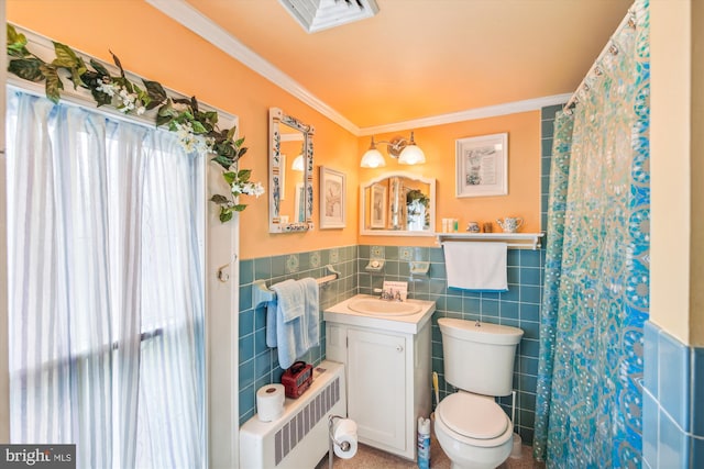 bathroom featuring toilet, radiator, ornamental molding, and tile walls