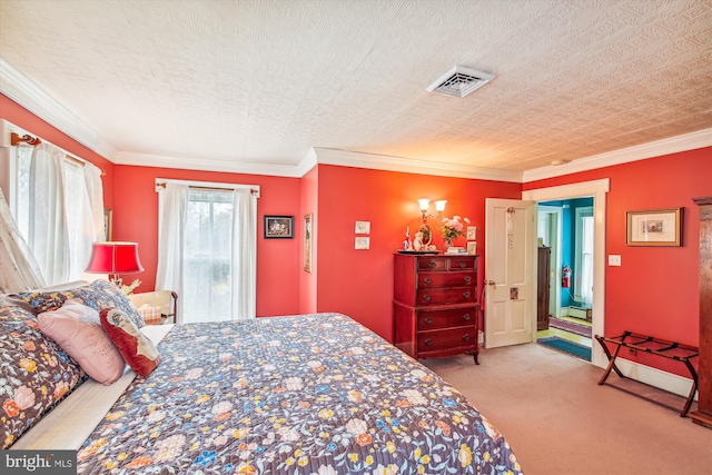 bedroom featuring a textured ceiling, carpet floors, and ornamental molding