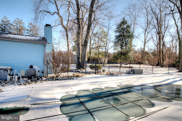 snow covered pool with a patio area