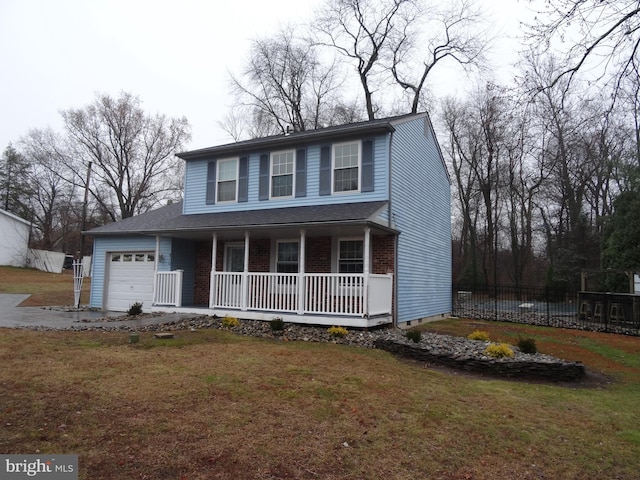 view of front of house with a front yard, a porch, and a garage