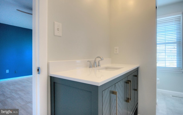 bathroom featuring vanity and toilet