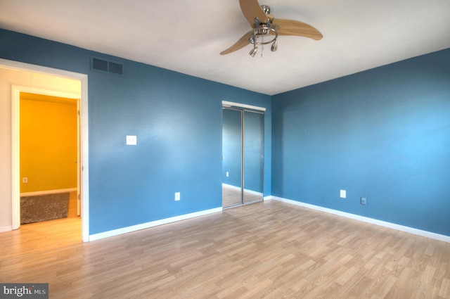 interior space featuring light wood-type flooring, a closet, and ceiling fan