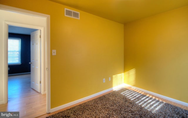 spare room with hardwood / wood-style flooring