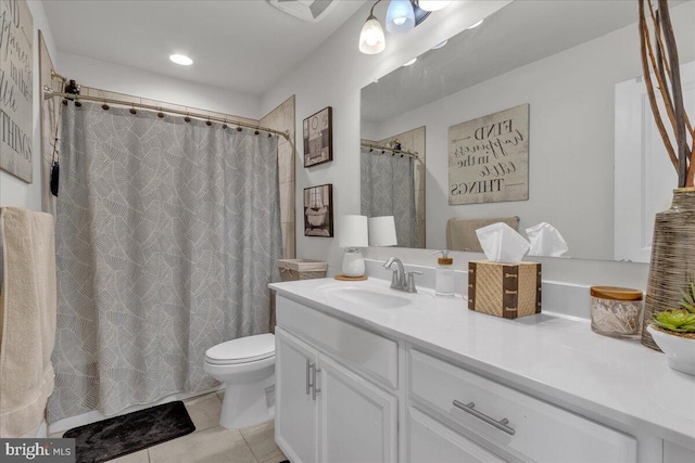 bathroom with tile patterned flooring, vanity, and toilet